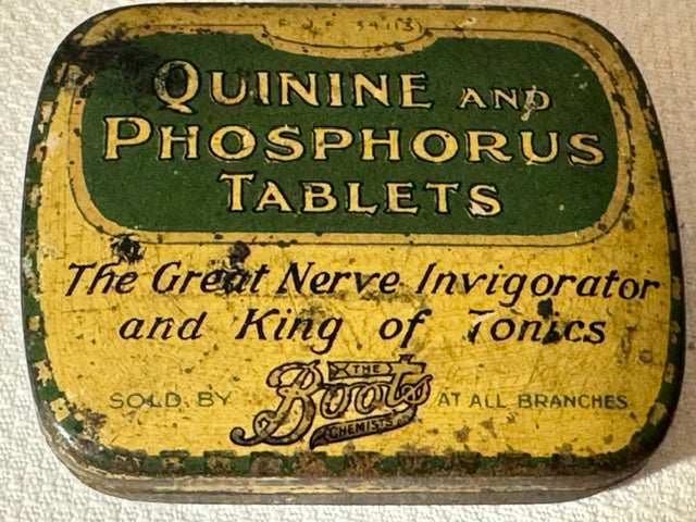 An antique round metal tin label for 'Quinine and Phosphorus Tablets' by 'The Boot's Apothecary', featuring a distressed yellow and green design with aged lettering.